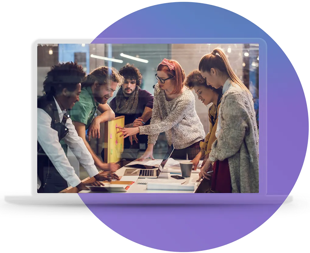 A cross-functional AICD team reviewing priorities together around a laptop